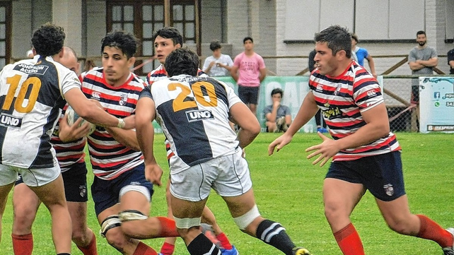 El capit&aacute;n Guillermo Botta (h) intenta sortear a un par de jugadores de Estudiantes que se impuso por 30 a 25.