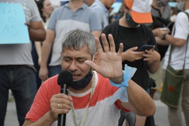 Un pastor evangelista dando oraciones al público en medio de avenida Hipólito Irigoyen.