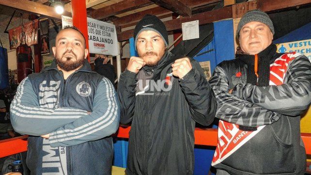 El Chino Farías junto a sus entrenadores, Walter Zoccola y Osvaldo Salami en la escuela de boxeo Olimboxing.